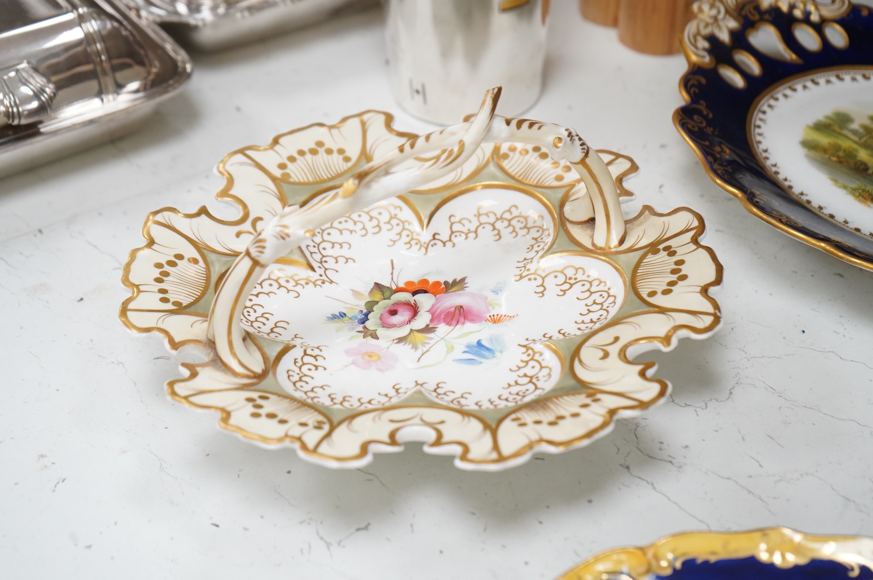 A collection of 19th century English dessert wares to include a pair of Flight, Barr and Barr ‘fantastic birds’ green ground dessert plates, various Ridgway dessert plates, five Minton botanical plates with tooled gilt b